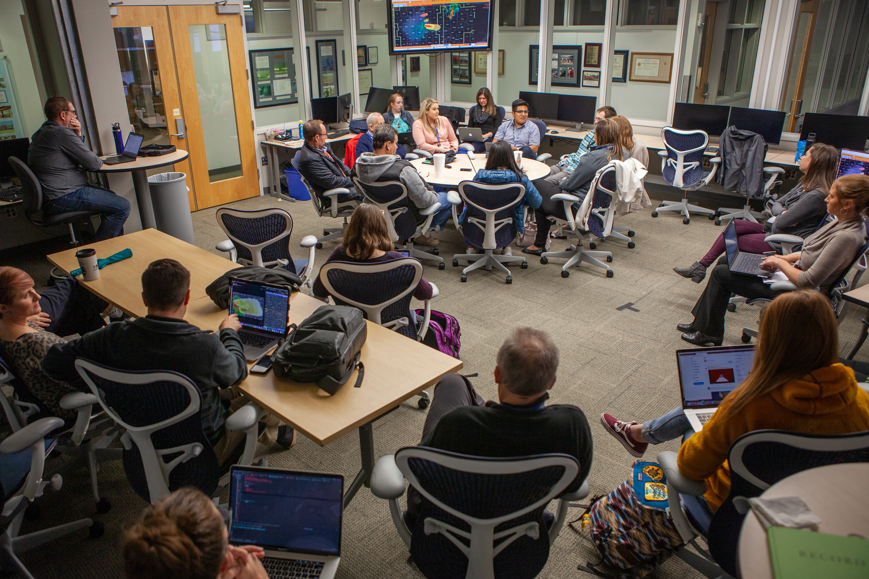 A group of people gathered around a table having a discussion.